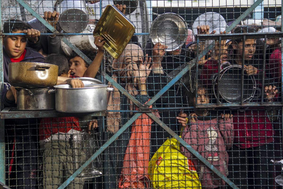 Crowd of starving Palestinians, including children, wait to receive food distributed by charity organizations amid Israel's blockade as the situation dramatically deteriorates in Jabalia refugee camp, Gaza on March 27, 2024. [Mahmoud Issa - Anadolu Agency]