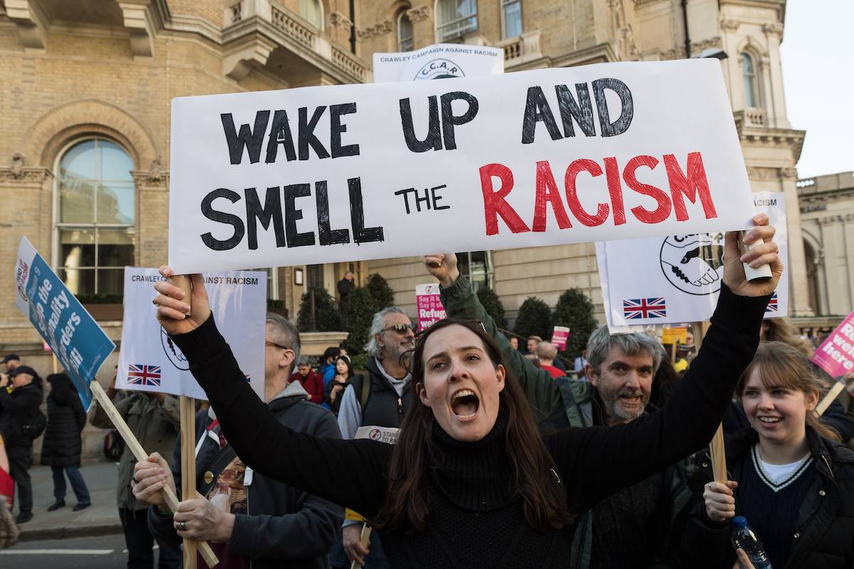 Demonstrators gather outside the BBC Broadcasting House ahead of a march to oppose racism, Islamophobia, antisemitism and fascism, and to express support for refugees as part of United Nations Anti-Racism Day in London, United Kingdom on March 19, 2022.[Photo by Wiktor Szymanowicz/Anadolu Agency via Getty Images]