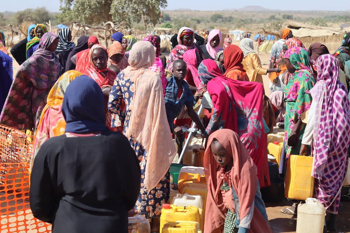 Refugees fleeing the conflict in Sudan queue with their jerrycans to queue to collect drinking water from the Doctors Without Borders (MSF) distribution point at the Ourang refugee camp in Adre on December 7, 2023. [DENIS SASSOU GUEIPEUR/AFP via Getty Images]