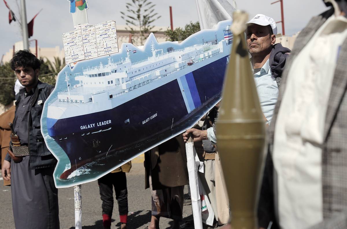Yemeni tribesmen belonging to the Houthi movement carry a model of the Houthi-hijacked Israeli Galaxy Leader cargo ship while participating in a popular parade and rally held to support Palestinians and against the US-UK aerial attacks on Yemen, on February 7, 2024, in Sana'a, Yemen. [Mohammed Hamoud/Getty Images]