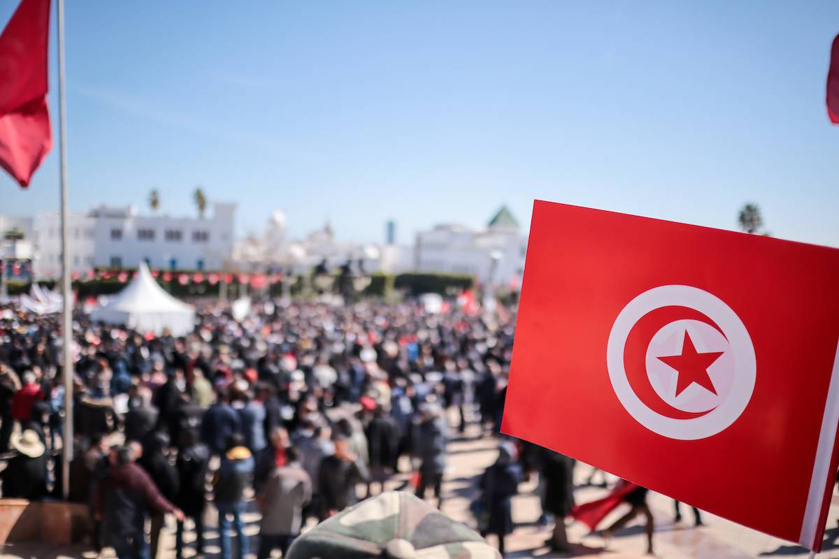 Protesters raising placards an anti-government demonstration at Al Kasbah Square in Tunis, Protest called by General Union of Tunisian Workers (UGTT), With economic hardships and concerns over political freedoms, the UGTT mobilized to defend workers' rights and demand political reform. on March, 02, 2024, Tunisia, [Hasan Mrad/UCG/Universal Images Group via Getty Images]