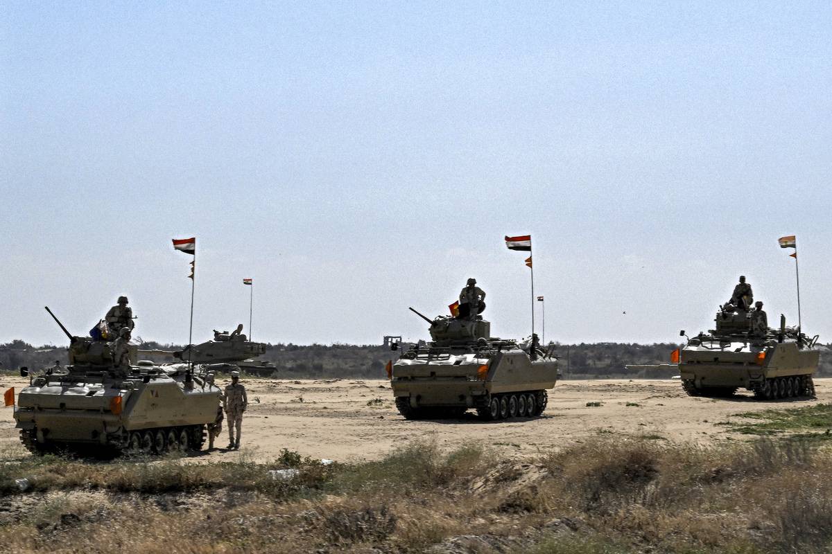 Egyptian army infantry fighting vehicles (IFV) are deployed near the Egyptian side of the Rafah border crossing with the Gaza Strip on March 23, 2024. [Photo by KHALED DESOUKI/AFP via Getty Images]