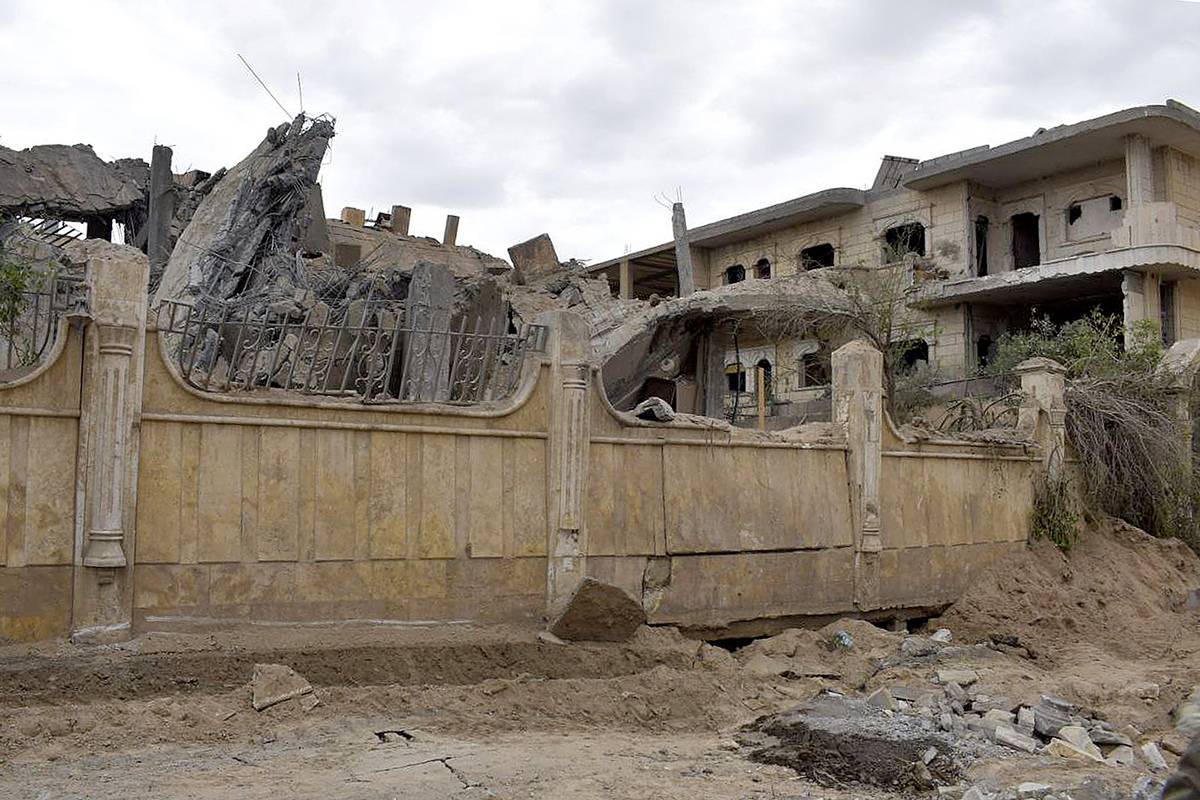 This picture taken on March 26, 2024 shows a view of a damaged building following an air strike in Syria's eastern city of Deir Ezzor. At least nine pro-Tehran fighters, including an Iranian Revolutionary Guards commander, were among 13 people killed in air strikes in eastern Syria. [Photo by -/AFP via Getty Images]