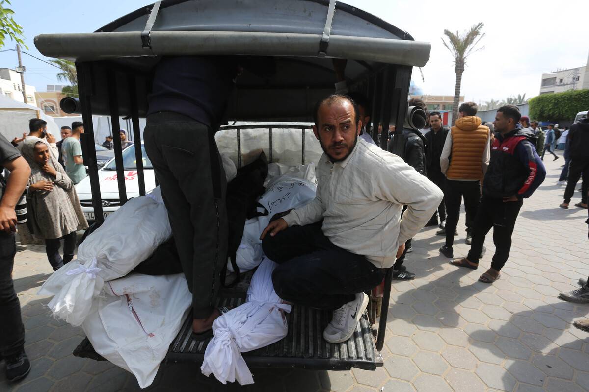 Dead bodies of Palestinians killed in the Israeli attacks on the house belonging to the Abu Gula family at Nuseirat refugee camp, are taken from the morgue of al-Aqsa Martyrs Hospital for burial in Deir Al-Balah, Gaza on April 10, 2024. [Ashraf Amra - Anadolu Agency]