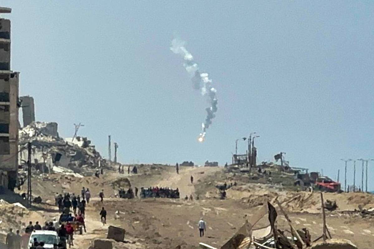Israeli forces intervene with gas bombs against Palestinians gathered on Al-Rashid Street to cross into northern Gaza after rumors spread that children and women under the age of 14 were allowed to cross the north in Gaza City, Gaza on April 14, 2024. [Ayman Alhesi - Anadolu Agency]