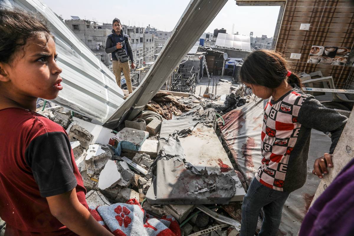 Children are seen among the rubble of destroyed building following an Israeli strike hit the house belonging to a displaced family in Rafah, Gaza on April 16, 2024. [Abed Rahim Khatib - Anadolu Agency]