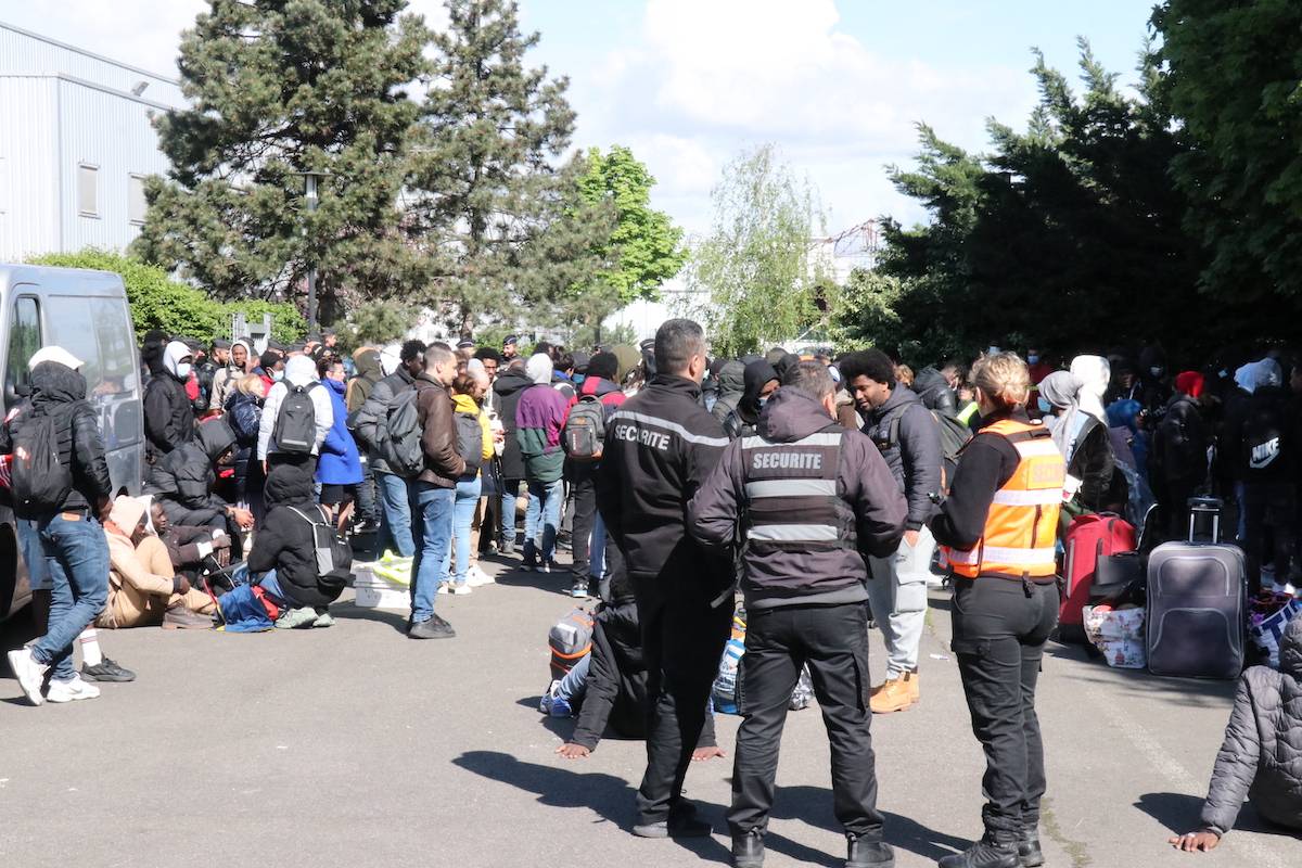 Police evacuate a building inhabited by about 450 people, mostly irregular migrants for the 2024 Paris Olympic Games as the immigrants leave the building with backpacks and suitcases in Vitry-sur-Seine district of Paris, France on April 17, 2024. [Ümit Dönmez - Anadolu Agency]