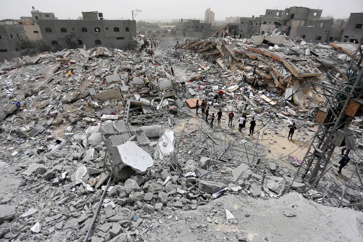 Palestinians living in Nuseirat Refugee Camp collect the usable items among the rubble of the destroyed buildings after Israel withdrawal from northern Nuseirat Camp in Deir Al Balah, Gaza on April 18, 2024. [Ashraf Amra - Anadolu Agency]