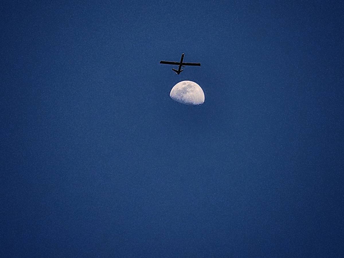 An unmanned aerial vehicle (UAV) belonging to the Israeli army is seen as the moon rises in the sky over Rafah where Israeli attacks continue on Gaza on April 17, 2024. [Hani Alshaer - Anadolu Agency]