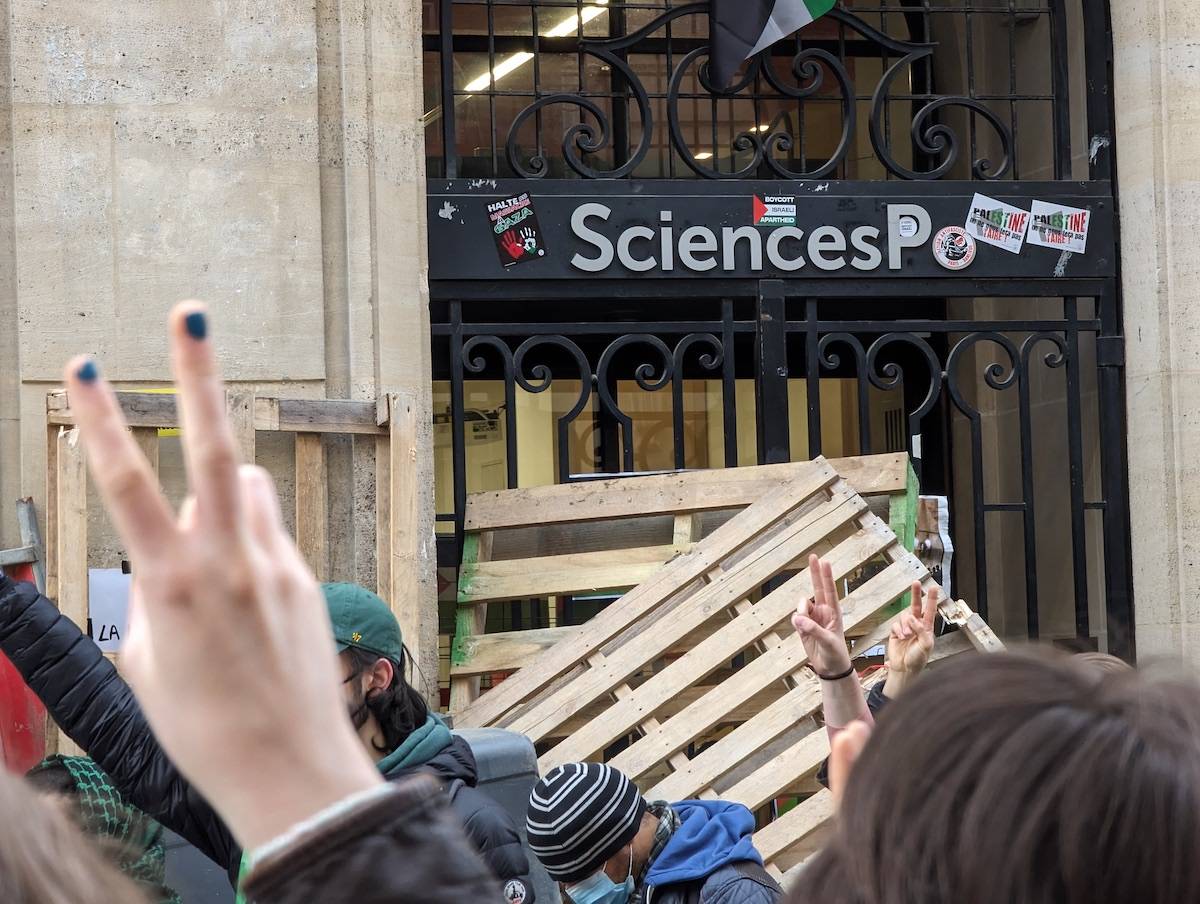 Students at Sciences Po University block entrance to one of the university's buildings after the police attempted to clear an encampment within a pro-Palestinian protest on Wednesday, in Paris, France on April 26, 2024. [Luc Auffret - Anadolu Agency]