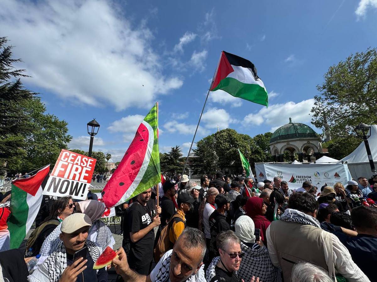 People, holding banners and Palestinian flags, gather at the Sultanahmet Square to protest Guinea-Bissau for removing its flag from ships carrying humanitarian aid to Gaza on April 27, 2024 in Istanbul, Turkiye. [Erol Değirmenci - Anadolu Agency]