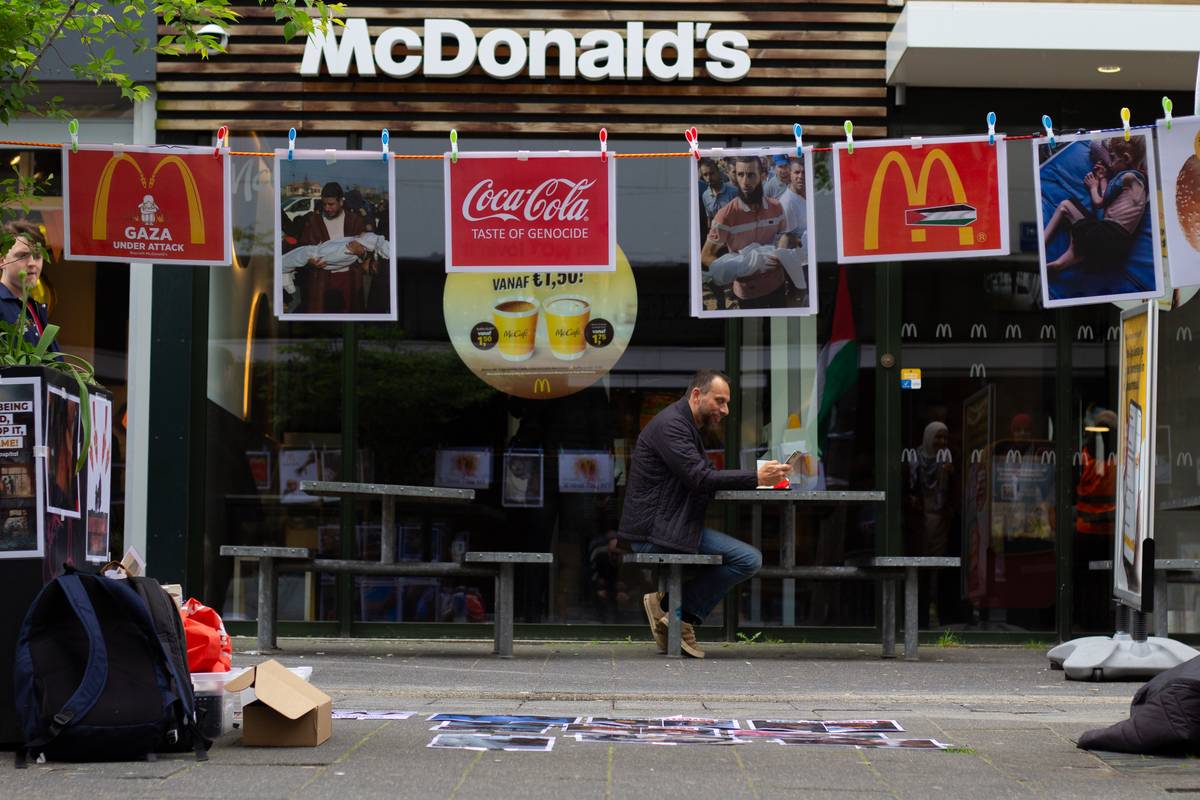 Banners and photos showing explaining Israel's attacks in Gaza Strip are seen in front of the McDonald's branch as a group of protestors gathered in front of McDonald's branch in Rotterdam city center, carrying banners against Israel and the company on April 28, 2024 in Rotterdam, Netherlands. [Abdullah Aşıran - Anadolu Agency]