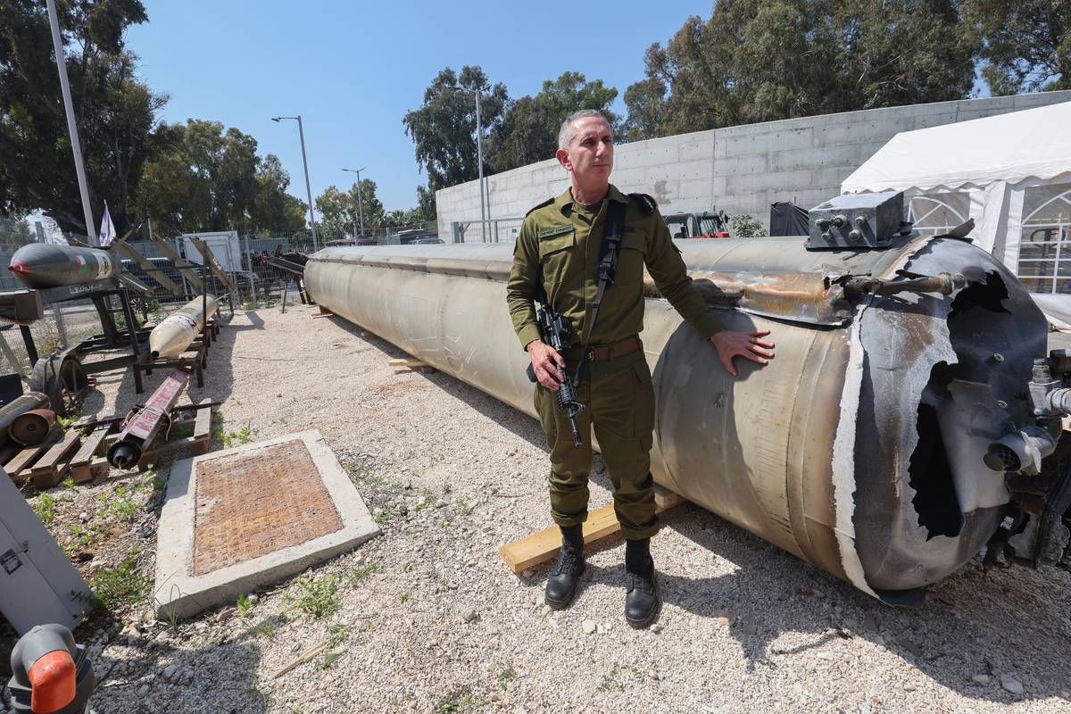 Israeli military spokesman Rear Admiral Daniel Hagari poses next to an Iranian ballistic missile which fell in Israel on the weekend, during a media tour at the Julis military base near the southern Israeli city of Kiryat Malachi on April 16, 2024. [Photo by GIL COHEN-MAGEN/AFP via Getty Images]