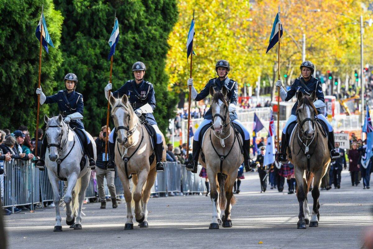 Mounted police are seen heading Anzac Day parade at Shrine