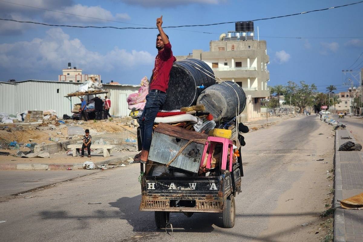Palestinians carry their belonging as they leave their homes due to Israel's attacks in Rafah, Gaza on May 12, 2024. [Hani Alshaer - Anadolu Agency]