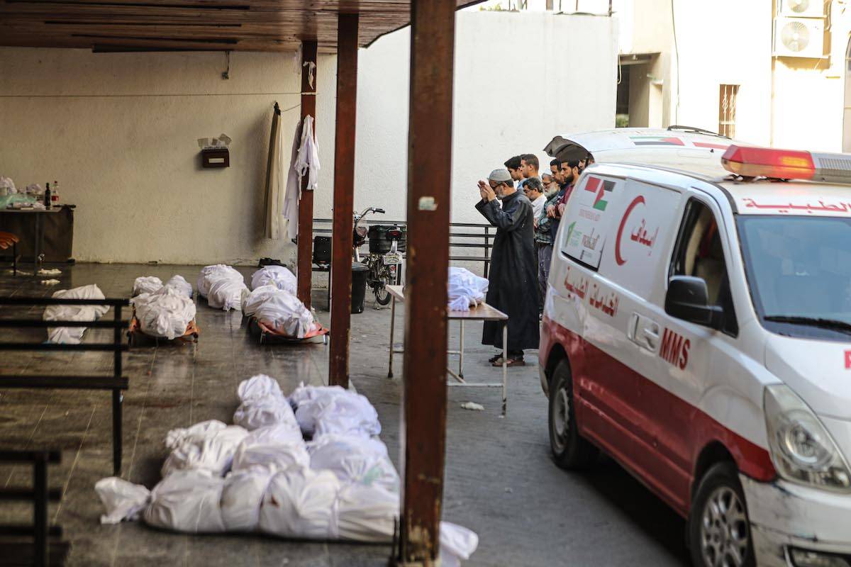 Palestinians perform the funeral prayer after the bodies of the Palestinians are brought to Al-Ahli Baptist who killed in Israeli attack shelled a house in al-Daraj neighborhood Hospital, in Gaza on May 23, 2024. [Dawoud Abo Alkas - Anadolu Agency ]