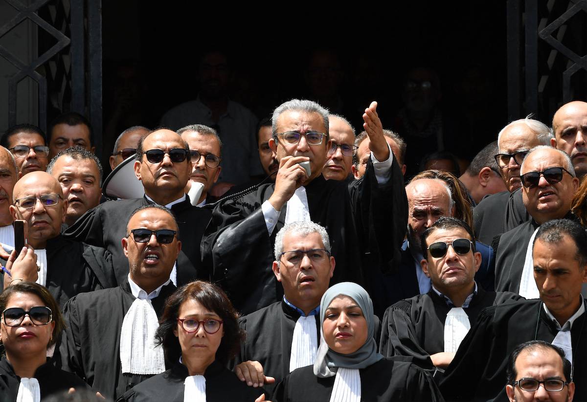 President of the Tunisian Lawyers' Bar Hatem Miziou (C) speaks in front of the courthouse in Tunis on May 16, 2024, during a demonstration by lawyers against the country's president following the recent arrests of colleagues. [FETHI BELAID/AFP via Getty Images]