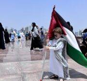 A child holds a Palestinian flag as people attend funeral ceremony, held for Hamas political chief Ismail Haniyeh, who was assassinated in Tehran, at Imam Abdul Wahhab Mosque in Doha, Qatar on August 2, 2024. [Ali Altunkaya - Anadolu Agency]