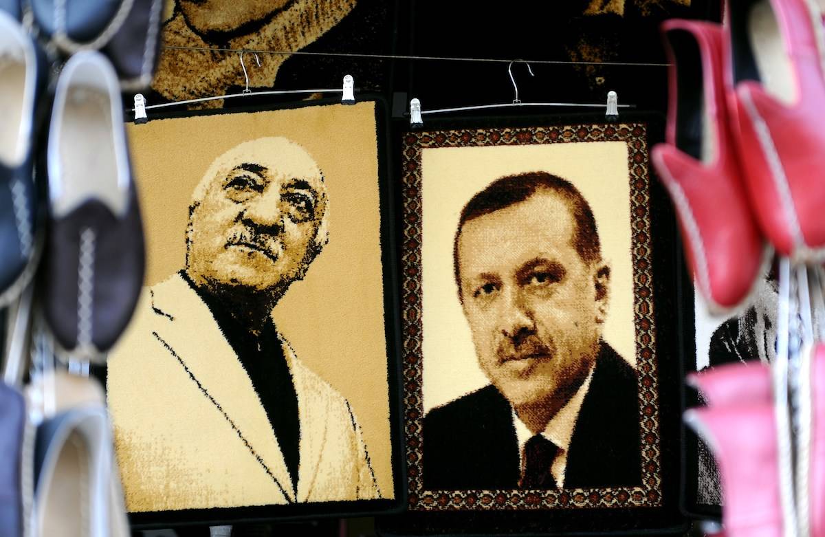 Embroidered images of United States-based Turkish cleric Fethullah Gulen (L) and Turkey's Prime Minister Recep Tayyip Erdogan (R) are displayed in a shop in the Gaziantep market on January 17, 2014 in Gaziantep, near the Turkish-Syrian border. [OZAN KOSE/AFP via Getty Images]