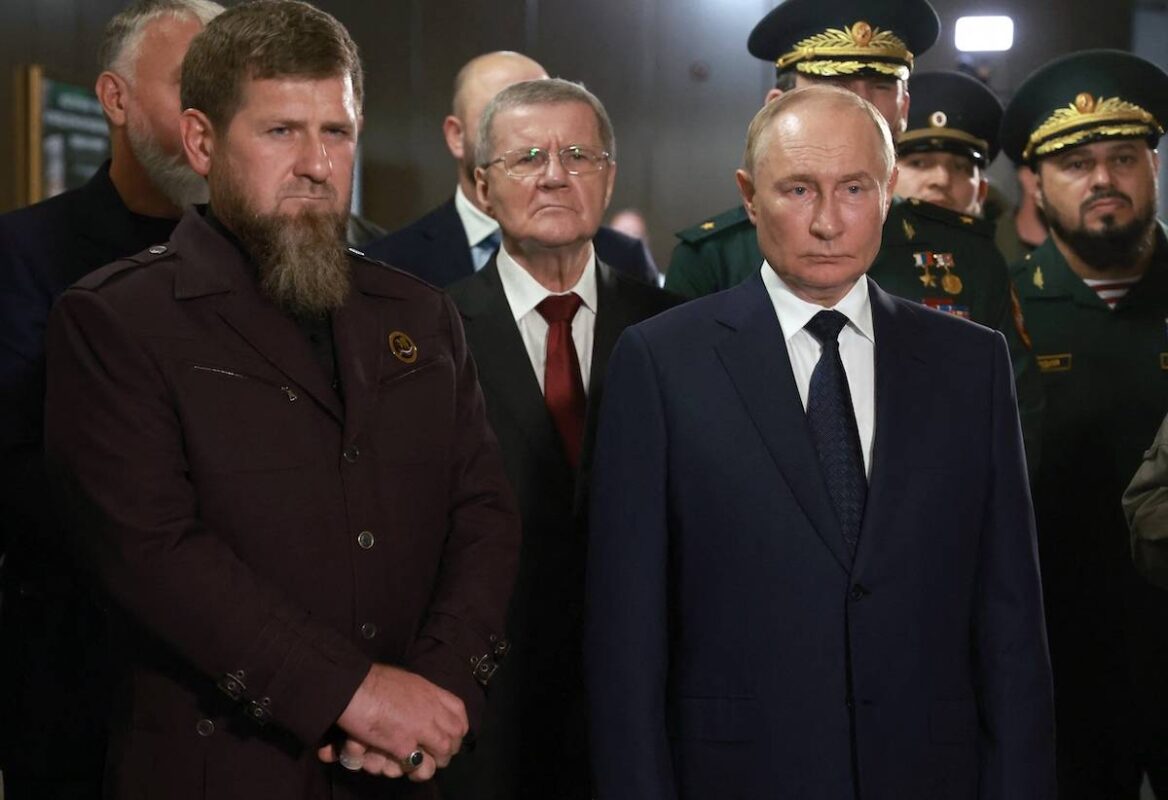 In this pool photograph distributed by Russian state owned Sputnik agency Russia's President Vladimir Putin (C-R) and  head of the Chechen Republic Ramzan Kadyrov (L) visit the "Russian Spetsnaz University" special force training centre in Gudermes on August 20, 2024. [VYACHESLAV PROKOFYEV/POOL/AFP via Getty Images]