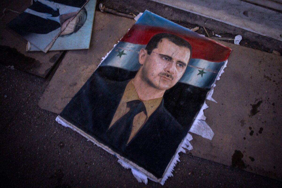 A ripped poster of former Syrian President Bashar al-Assad lies on the ground outside the Interior Ministry building on December 17, 2024 in Damascus, Syria [Chris McGrath/Getty Images]