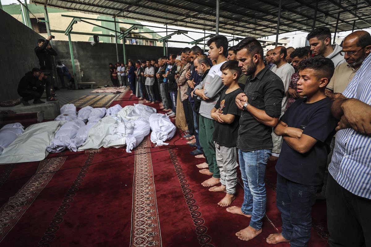 Palestinians participate in a funeral ceremony and perform funeral prayer for those who lost their lives in an Israeli attack on a displacement shelter, at Al-Rafe'ie School in Jabalia, Gaza on May 12, 2025. [Mahmoud İssa - Anadolu Agency]