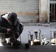 Palestinians make a babur, a traditional kerosene stove, which is being manufactured in light of the cooking gas crisis in Gaza. [Mohammed Asad/MiddleEastMonitor]