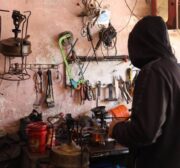 Palestinians make a babur, a traditional kerosene stove, which is being manufactured in light of the cooking gas crisis in Gaza. [Mohammed Asad/MiddleEastMonitor]