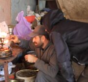 Palestinians make a babur, a traditional kerosene stove, which is being manufactured in light of the cooking gas crisis in Gaza. [Mohammed Asad/MiddleEastMonitor]