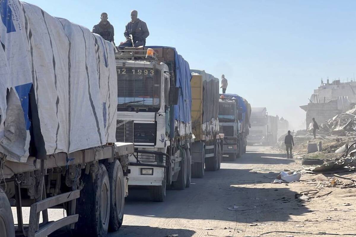 Trucks carrying aid passing through the Kerem Abu Salim Border Gate reaching to Gaza Strip are moving on the road after the third day of the ceasefire and hostage-prisoner swap deal between Hamas and Israel in Gaza Strip on January 21, 2025. [Anas Zeyad Fteha - Anadolu Agency]