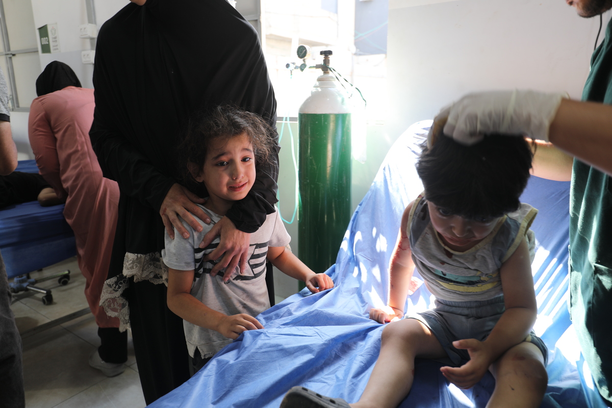 Palestinians receive medical treatment at Al Awda Hospital after the Israeli attack that hit a water refill point belonging to displaced Palestinians in the “New Camp” area northwest of Nuseirat Camp, killing 10 people, including 6 children, in Gaza City, Gaza on July 13, 2025. [Moiz Salhi - Anadolu Agency]