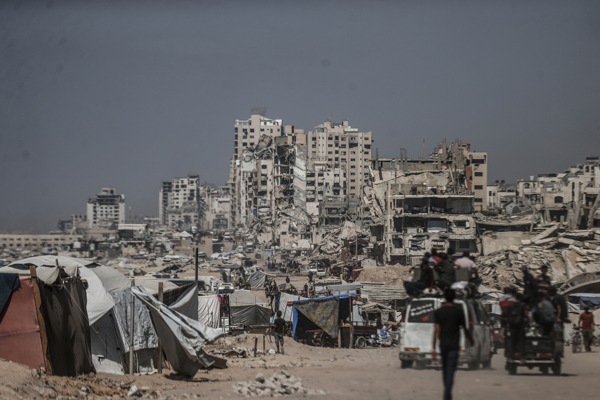 A view of the tent city along the shore of Gaza City, with buildings destroyed by the Israeli attacks in the background as Palestinians struggle to survive with limited shelter, food and basic necessities in Gaza City, Gaza on August 24, 2025. [Ali Jadallah - Anadolu Agency]