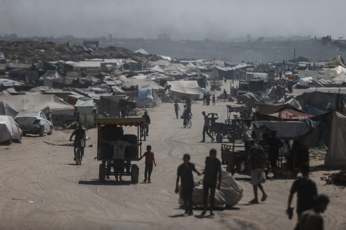 A view of the tent city along the shore of Gaza City, with buildings destroyed by the Israeli attacks in the background as Palestinians struggle to survive with limited shelter, food and basic necessities in Gaza City, Gaza on August 24, 2025. [Ali Jadallah - Anadolu Agency]
