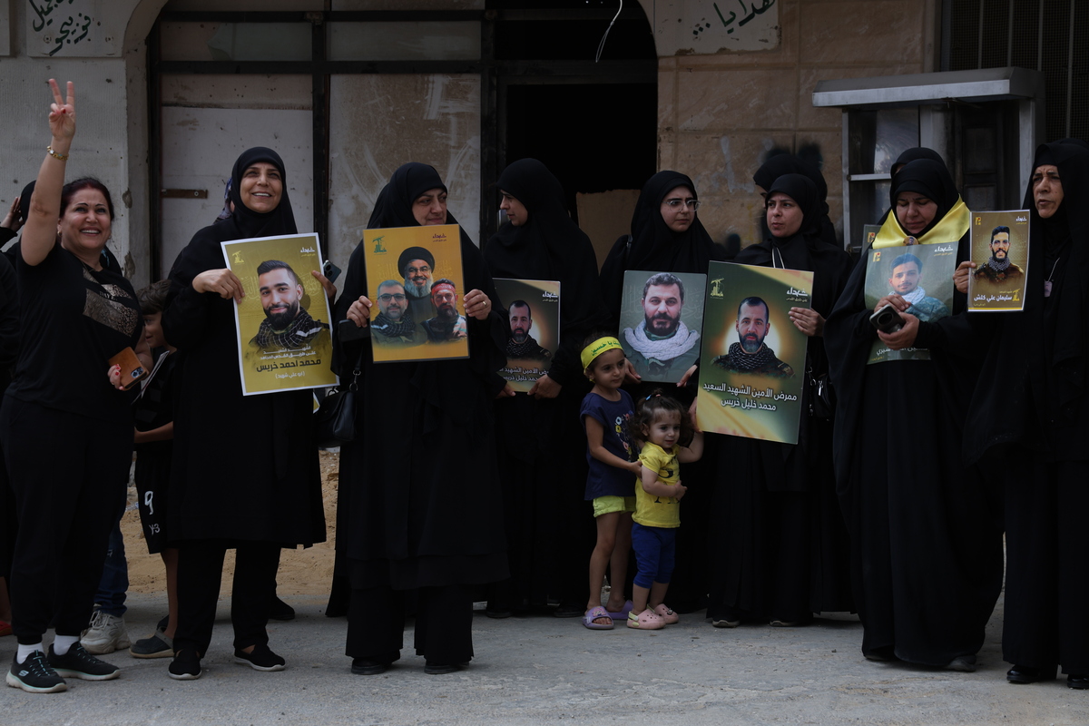 A group of demonstrators, holding banners, placards and photos of Hezbollah members killed by Israeli army in the town along with Lebanese flags, gather to hold a demonstration carrying Hezbollah flags after the U.S. Ambassador to Ankara and Special Envoy for Syria Tom Barrack canceled his planned visit to Khiam, a town on the Israeli border, and the coastal city of Tyre in southern Lebanon, in Khiam, Lebanon on August 27, 2025. [Ramiz Dallah - Anadolu Agency]
