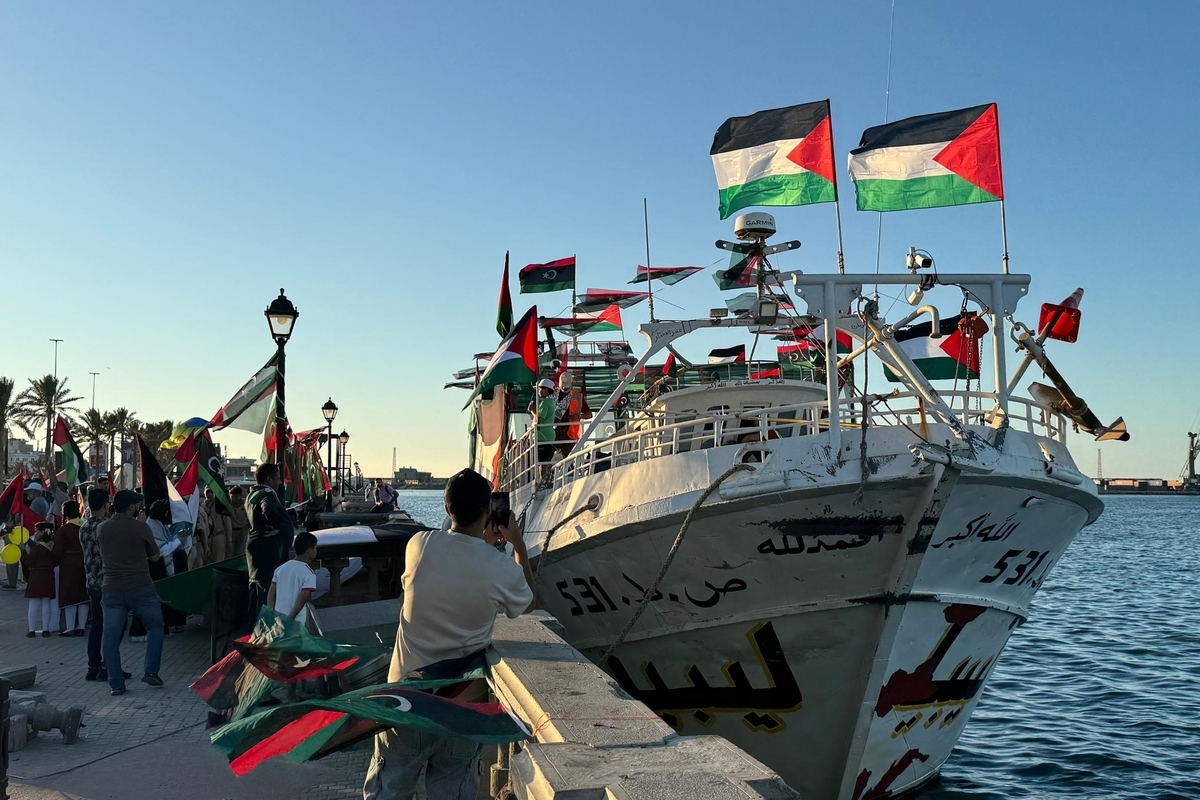 People, holding Palestinian flags, gather at the Port of Tripoli to show their supports as the "Omar al-Mukhtar" ship, which will join the Global Sumud Flotilla from Libya, prepares to leave in Tripoli, Libya on September 16, 2025. [Muhammed Semiz - Anadolu Agency]