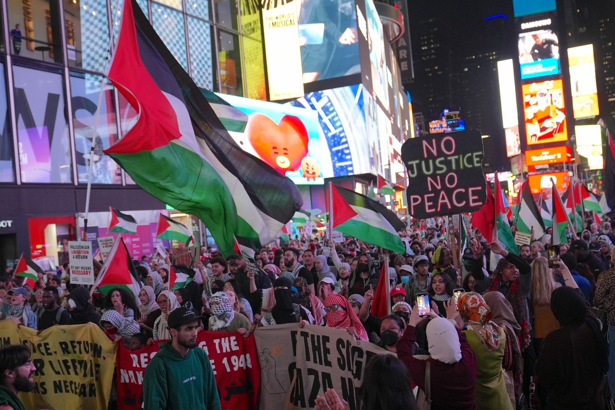 Pro-Palestine protesters, wearing Palestinians keffiyeh and carrying Palestinian flags and banners, attend the rally outside the News Corp headquarters, the home of Fox News and march to Hudson Yards in Manhattan, New York City, to mark two years since the outbreak of war in Gaza on October 07, 2025 in New York, United States. [Selçuk Acar - Anadolu Agency]