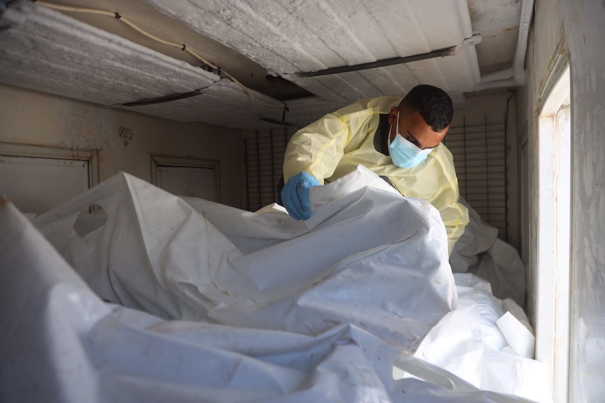 International Committee of the Red Cross (ICRC) teams receive the bodies of Palestinians detained by Israel in Gaza and hand over them to officials of the Palestinian Ministry of Health under the cease-fire and hostage-prisoner exchange agreement between Israel and Hamas, at a designated location near Nasser Hospital in Khan Yunis, Gaza on October 18, 2025. [Abdallah F.s. Alattar - Anadolu Agency]