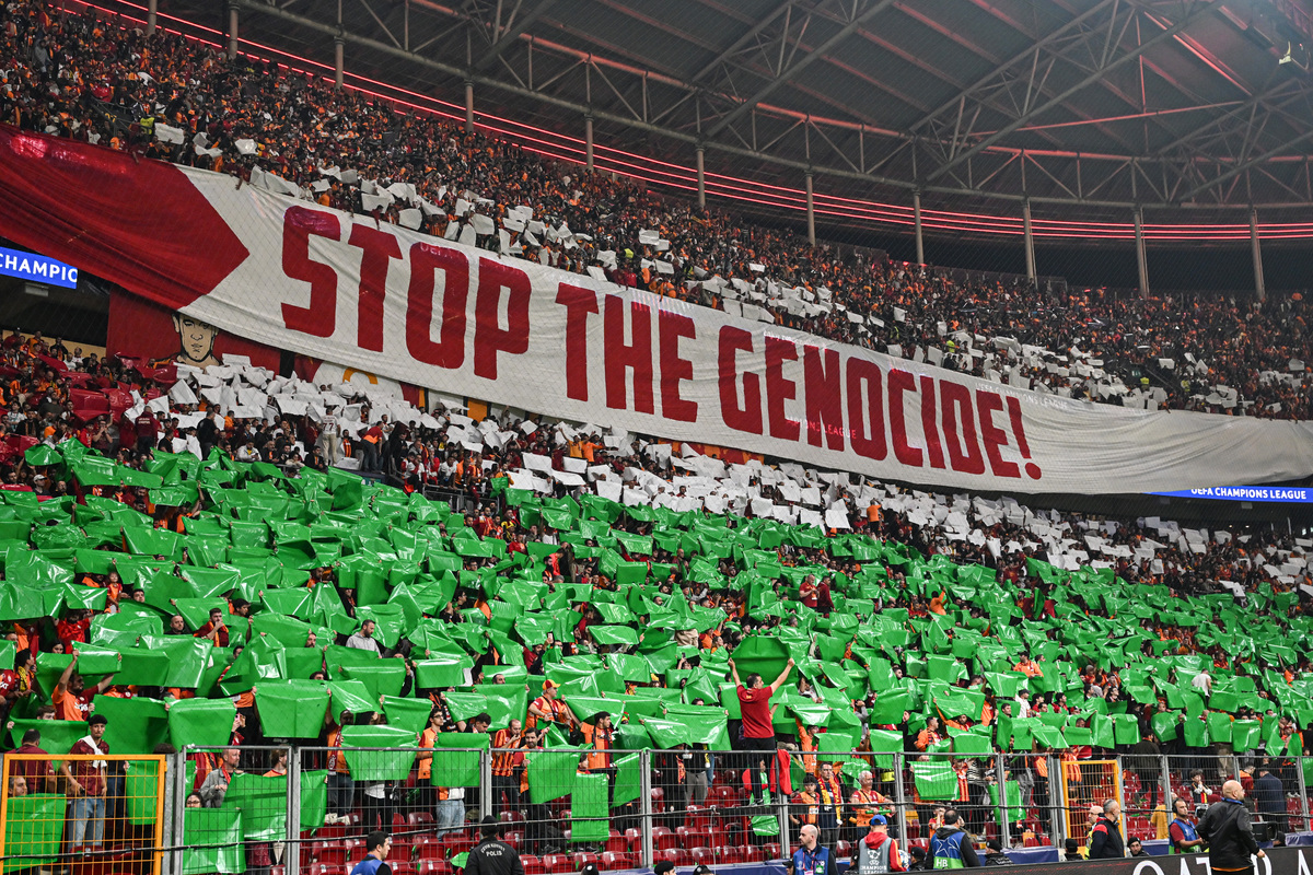 Galatasaray fans display a choreography reading “Stop The Genocide” in the colors of the Palestinian flag to show support for Palestine before the UEFA Champions League third-week match between Galatasaray and Bodo/Glimt at RAMS Park in Istanbul, Turkiye on October 22, 2025. [Elif Öztürk - Anadolu Agency]
