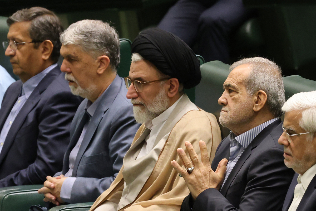 Iran's incumbent Minister of Intelligence Esmaeil Khatib (C) sits with Iran's President Masoud Pezeshkian (C-R) before a speech to members of parliament in the capital Tehran, on August 17, 2024, as he defends his cabinet selection. [Photo by ATTA KENARE/AFP via Getty Images]