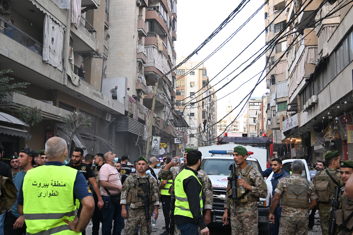 Security forces, civil defense, and firefighting teams arrive at the scene following an Israeli attack which killed five people and injured 28 violating the ceasefire in Dahieh region of Beirut, Lebanon on November 23, 2025. [Houssam Shbaro - Anadolu Agency]