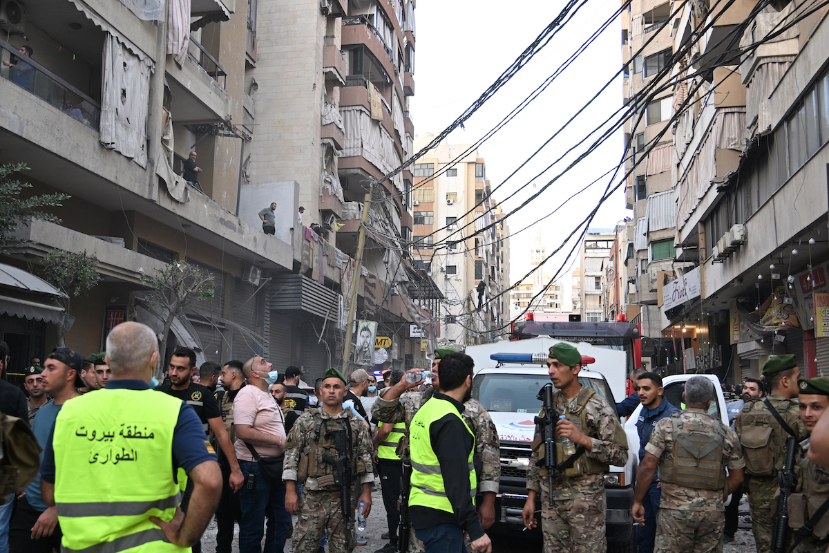Security forces, civil defense, and firefighting teams arrive at the scene following an Israeli attack which killed five people and injured 28 violating the ceasefire in Dahieh region of Beirut, Lebanon on November 23, 2025. [Houssam Shbaro - Anadolu Agency]