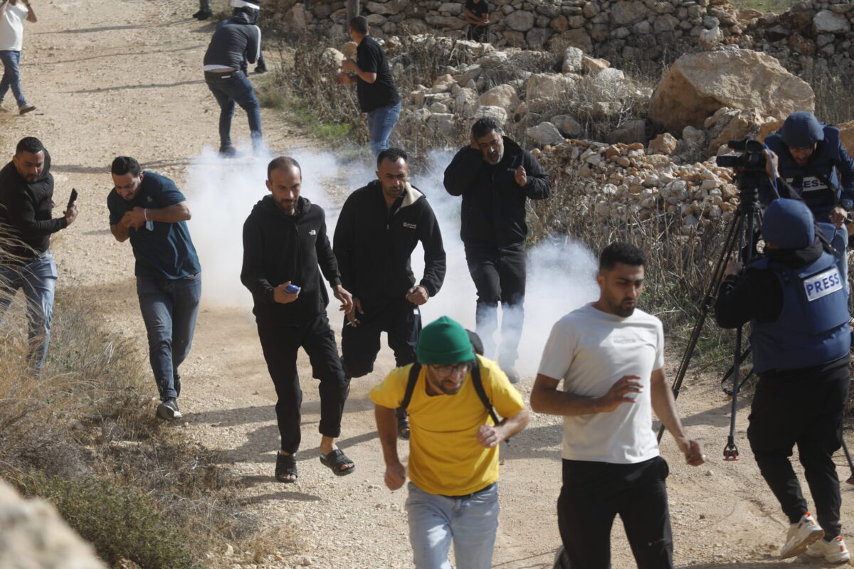Israeli forces and Israeli settlers block Palestinian farmers trying to access to their agricultural fields, with stun grenades and tear gas in the town of Tarqumiyah, in Hebron, West Bank on November 28, 2025. [Mamoun Wazwaz - Anadolu Agency]