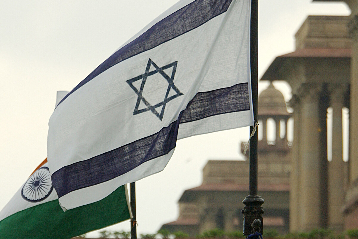 Israeli (R) and Indian (L) flags flutter in the wind in front of Government Buildings in New Delhi.[Photo by PRAKASH SINGH/AFP via Getty Images]
