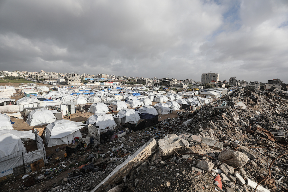Palestinians struggle as heavy rain and storm damage their tents in the Bureij Refugee Camp in central Gaza on January 13, 2026. Storms and heavy rainfall affecting the Gaza Strip have severely impacted the lives of Palestinians living in makeshift tents. [Moiz Salhi - Anadolu Agency]