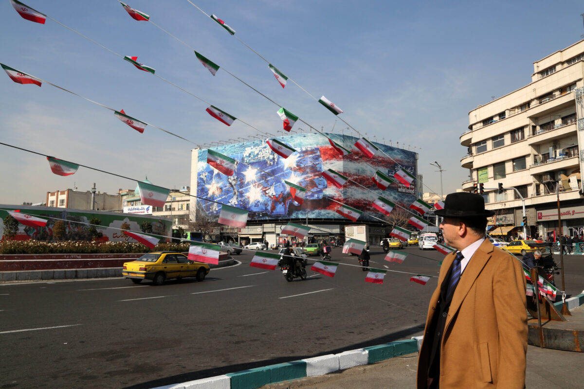 A man look at the anti-American posters and Iranian flags displayed following a possible US intervention against Iran on January 28, 2026 in Tehran, Iran. [Fatemeh Bahrami - Anadolu Agency]