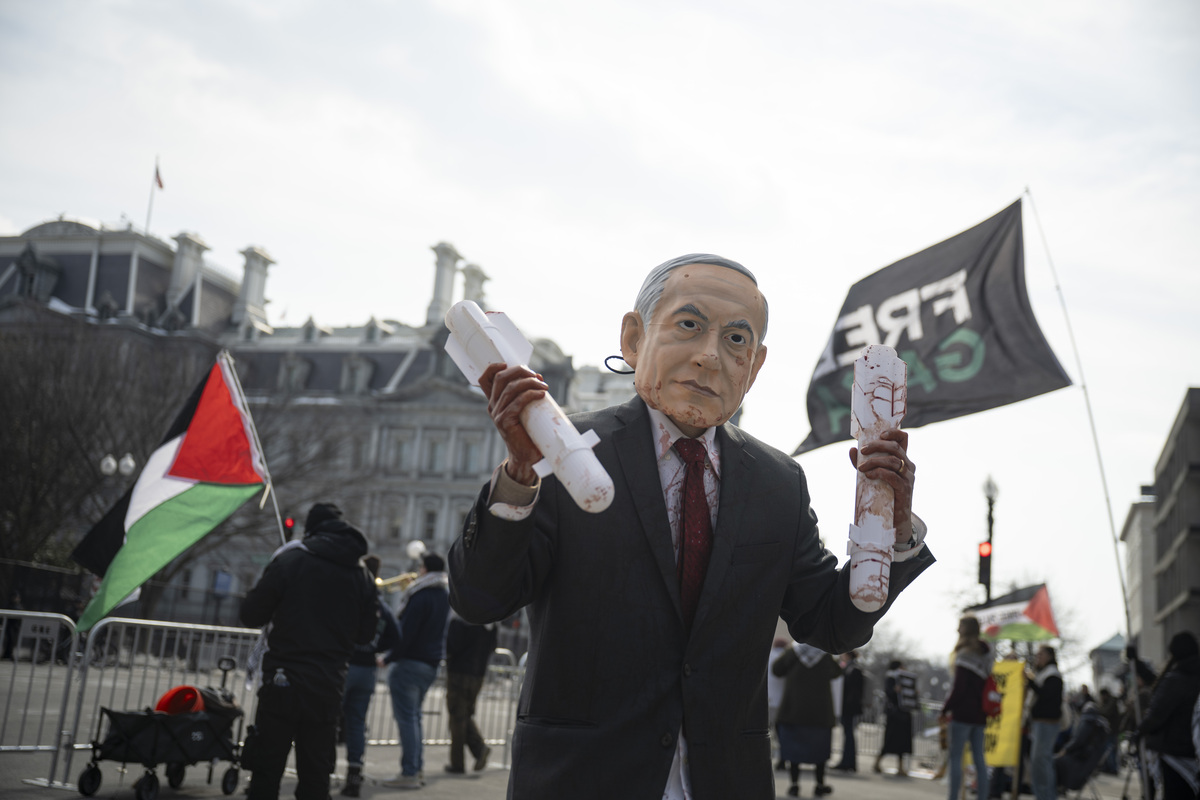 A protester wearing a Israeli PM Netanyahu mask is seen as protesters gathered outside the White House to demonstrate against Israeli Prime Minister Benjamin Netanyahu's visit to Washington, DC, on February 11, 2026. [Celal Güneş - Anadolu Agency]