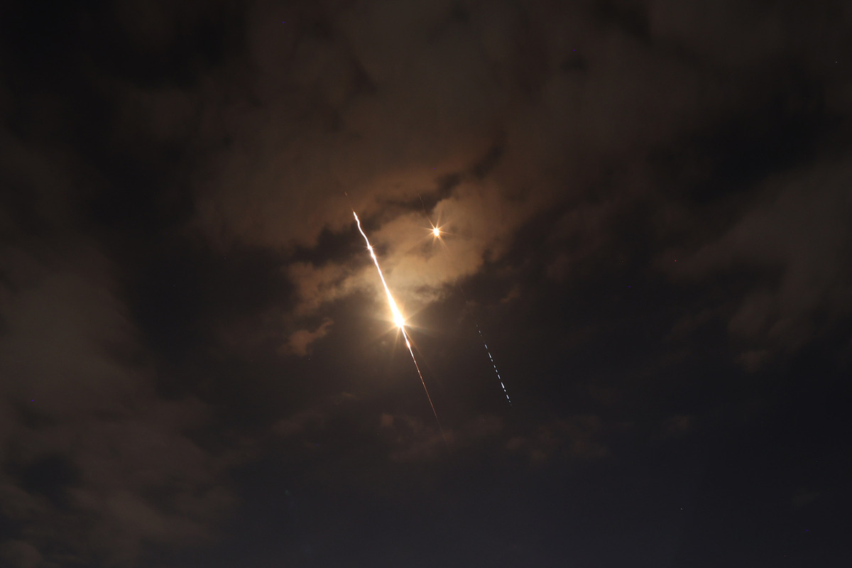 Missiles fired from Iran toward Israel are seen streaking across the night sky over Ramallah, Palestine on March 24, 2026. [Issam Rimawi - Anadolu Agency]