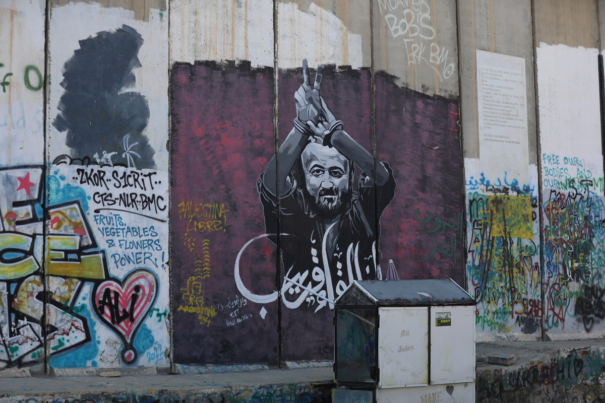 Graffiti supporting Palestinian prisoners is painted on Israel’s separation wall between Jerusalem and Bethlehem, calling for their freedom and protesting Israel’s proposed death penalty for Palestinian detainees in Bethlehem, West Bank, Palestine, on March 31, 2026. [Wisam Hashlamoun - Anadolu Agency]