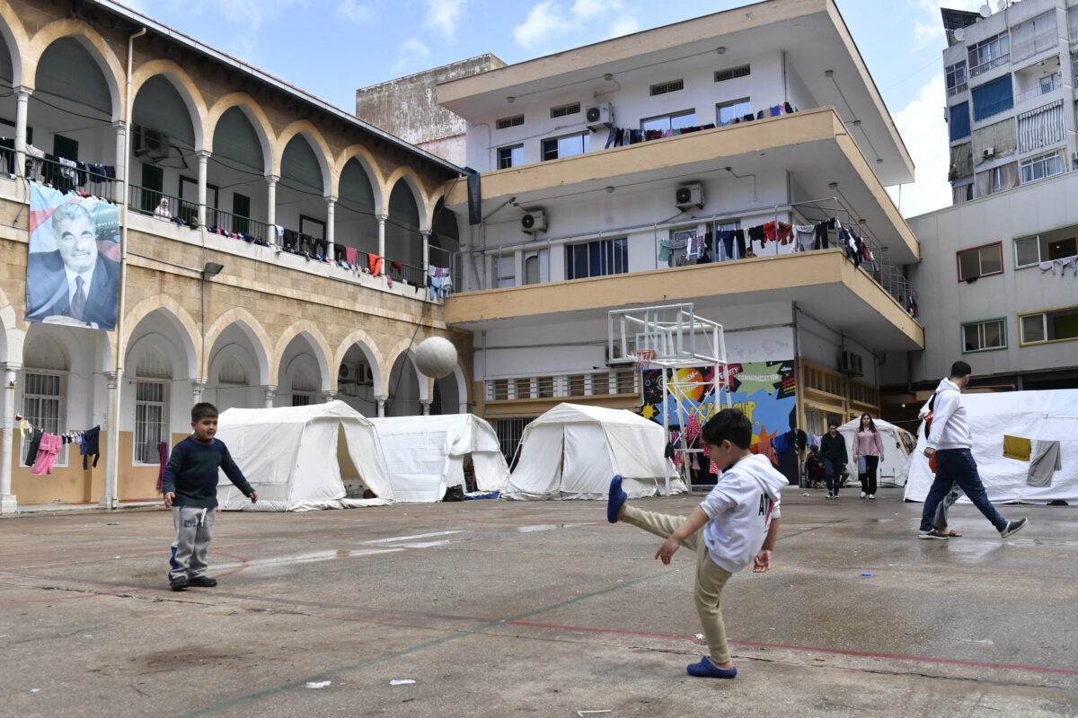 Lebanese families displaced by Israeli army attacks on southern Beirut take shelter in a school, living in classrooms and tents set up in the schoolyard after being forced to flee their homes in Beirut, Lebanon on March 27, 2026. [Houssam Shbaro - Anadolu Agency]