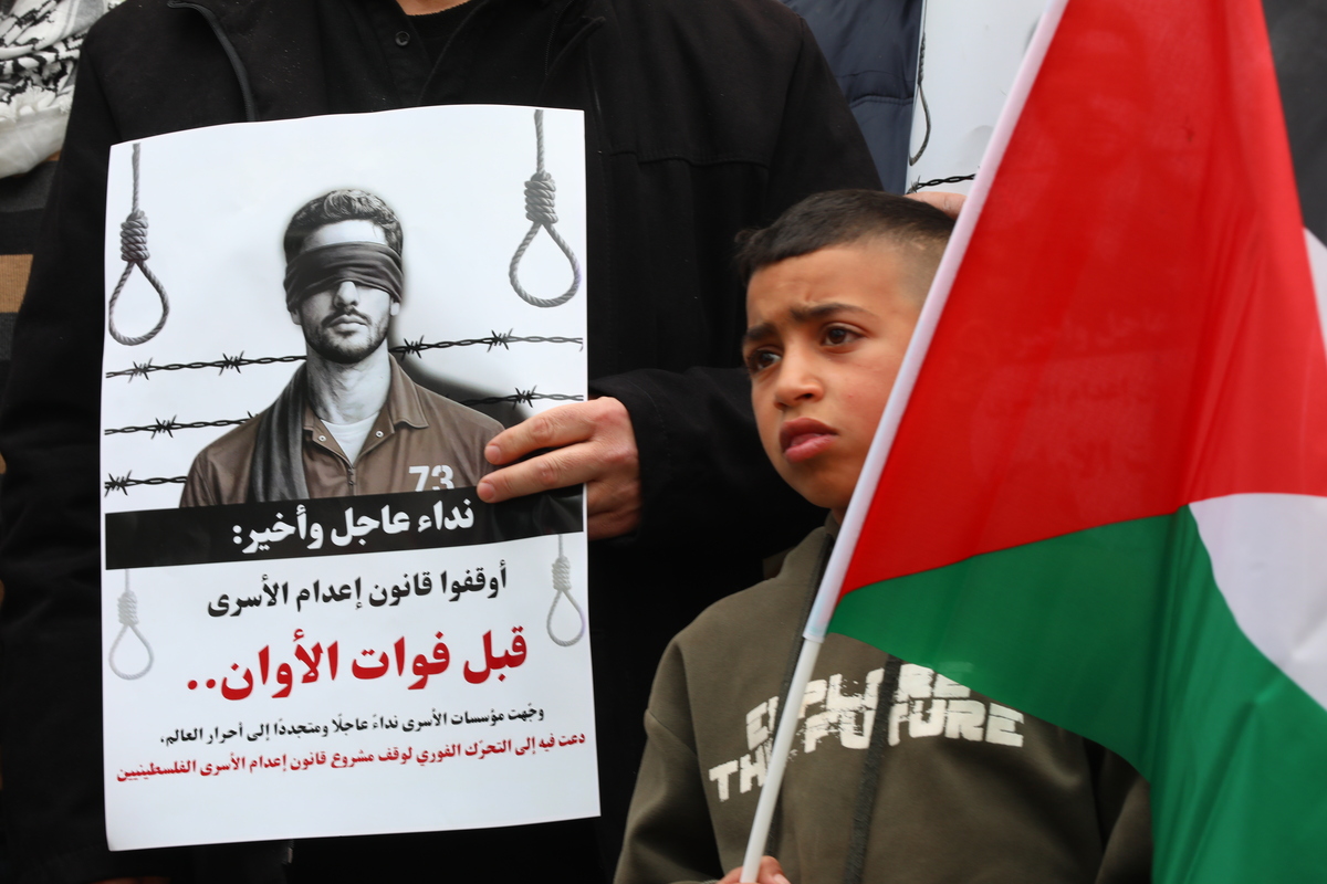 Demonstrators gather outside the International Committee of the Red Cross (ICRC) office to protest an Israeli law proposing the death penalty for Palestinian prisoners in Hebron, West Bank, Palestine on April 2, 2026. [Wisam Hashlamoun - Anadolu Agency]